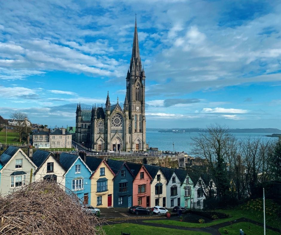 Blue skies over Cobh's cathedral and colourful houses, in County Cork, Ireland
