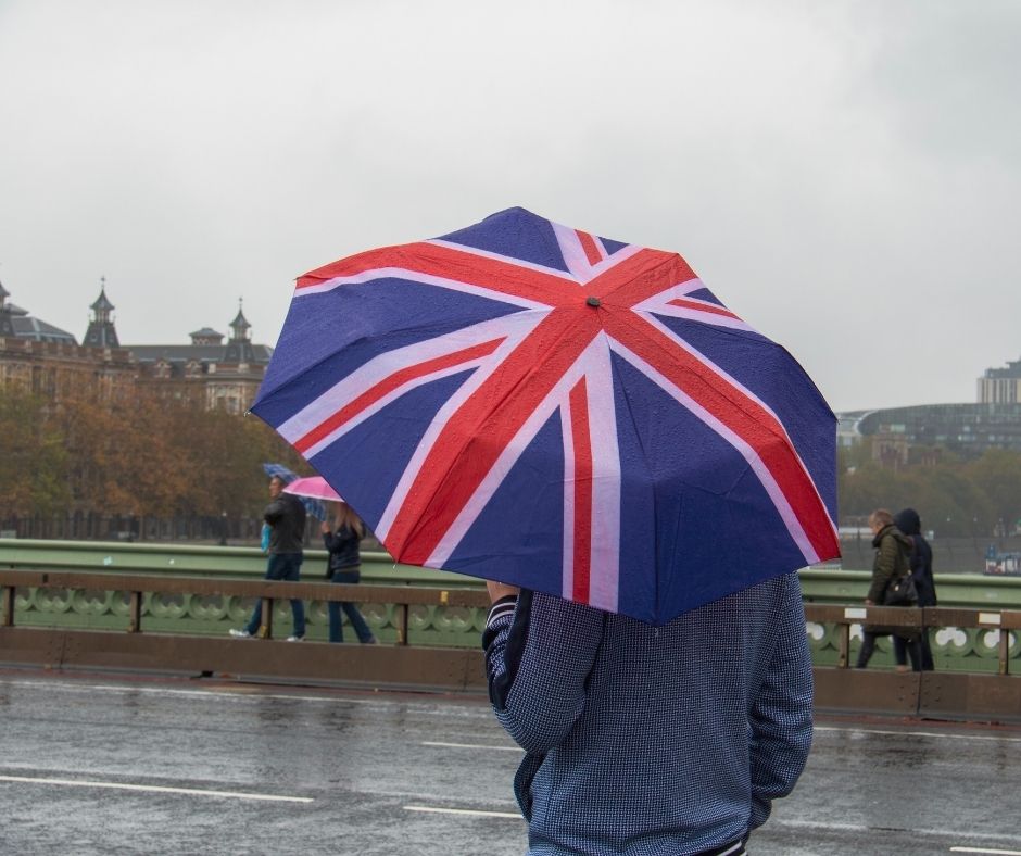 A person carries a Union Jack umbrella on a rainy day in London